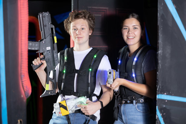 男孩和女孩在舞台上拿着激光枪摆姿势图片下载