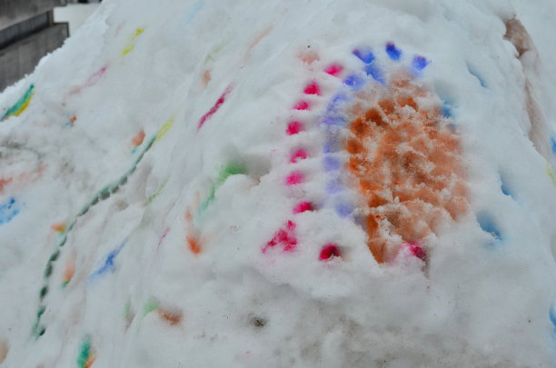 冬季艺术教育也可以在雪地里进行。可以用水彩在冰屋上画点。雪融化了，彩色斑点融化并伸展开来。儿童和学龄前儿童用画笔画画图片下载