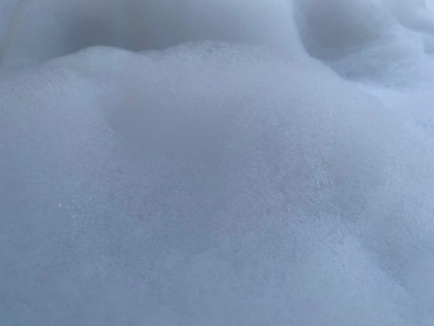 白色柔软泡沫浴缸。波浪形表面背景。图片下载