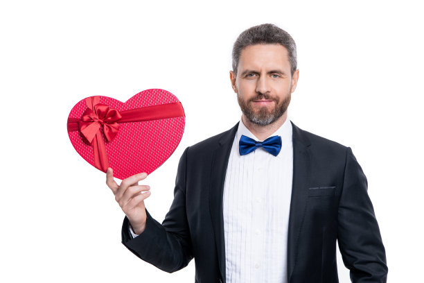 穿着燕尾服的男人拿着情人节礼物盒，在白色背景上隔离图片下载