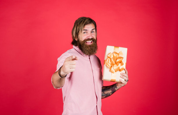 积极的人喜欢购物。成熟的男人带着礼盒看起来很随意。通常用于生日。购买周年纪念礼物。惊讶的男子打开纸箱，里面有一些令人兴奋的东西图片下载