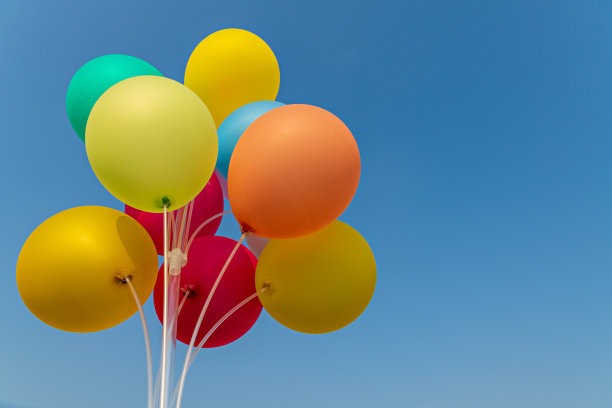 多色气球背景。蓝天背景上的彩色气球。生日、庆典及派对装饰概念。婚礼蜜月派对的概念。图片下载