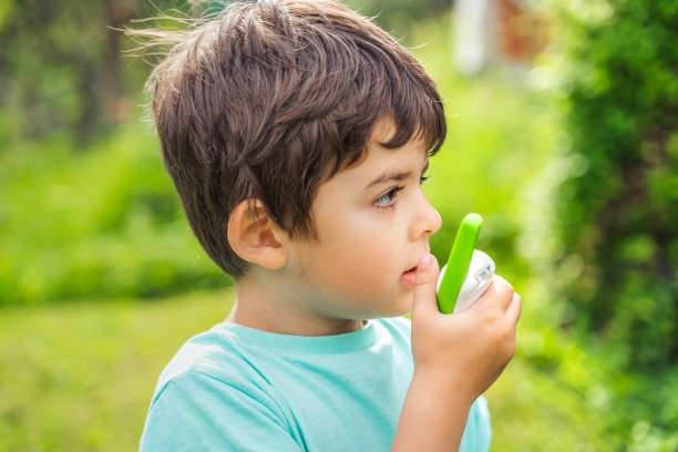 小男孩，小孩，小孩玩对讲机。带频道的对讲机。侦探和间谍的游戏。孩子们在远处交谈，传递信息。与家长沟通。森林公园,徒步旅行。寻找迷路的人图片下载