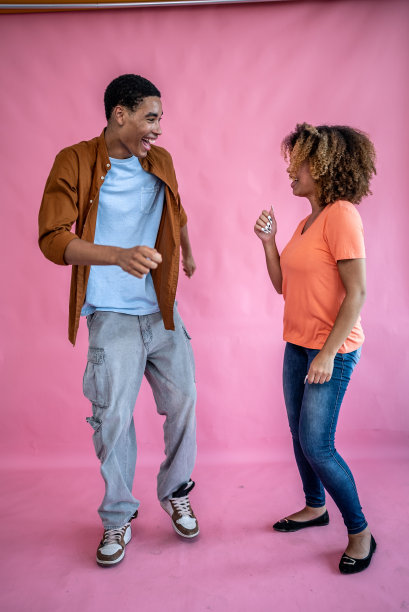 年轻的朋友们在粉红色的背景上跳舞图片下载