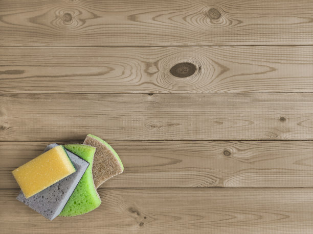 厨房海绵放在桌子上。平的。家庭清洁说明和技巧。发短信的地方。图片下载