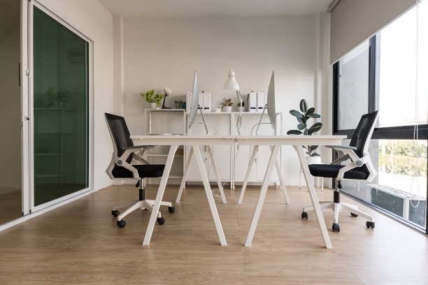 白色的桌子和椅子，电脑显示器和现代化的文件柜在白色的家庭办公室图片下载