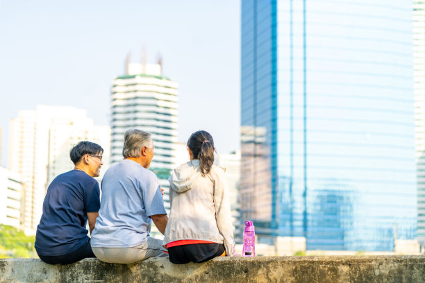 亚洲夫妇和年长的父亲一起在公园慢跑后休息。图片下载
