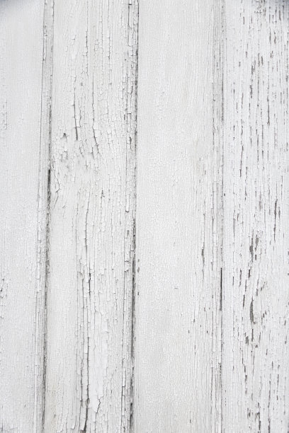 由于天气和时间的原因，涂有白色油漆的旧木板的垂直照片已经开裂和脱落图片下载