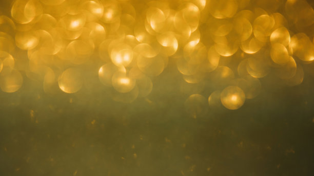 闪亮的金色模糊背景假日设计。圣诞模糊抽象闪耀，选择性聚焦图片下载