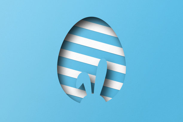 浅蓝色的纸剪成一个复活节彩蛋的图案。图片下载