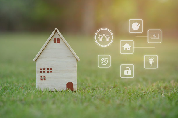 模型房子和图标在绿色草地模糊的背景。考虑买房、卖房或租房、自然环境和住房。图片下载