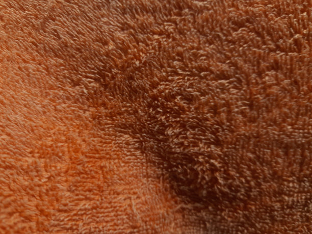 橙色的毛巾纹理特写。背景图片下载