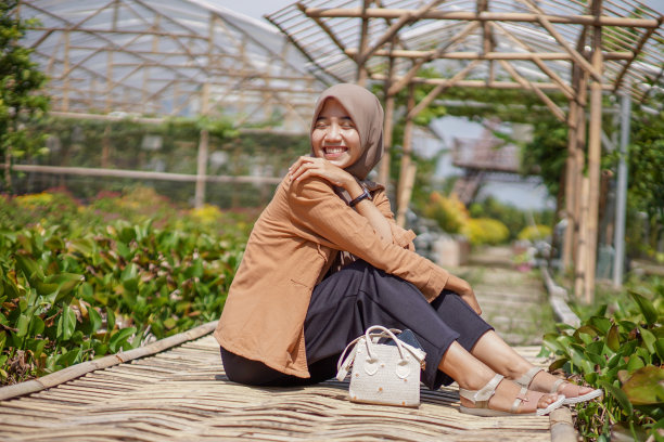 亚洲穆斯林妇女坐在竹桥上图片下载