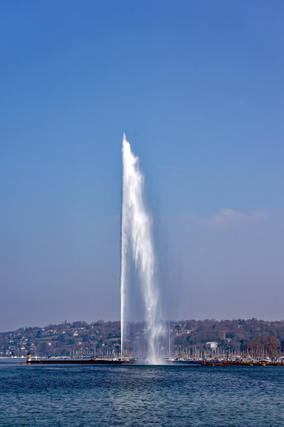 瑞士湖上的喷泉，蓝天背景和城市天际线。图片下载