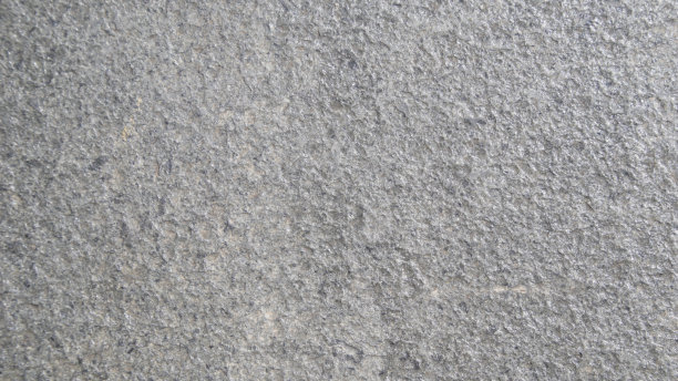 近距离观察粗糙的灰色石头表面。在自然环境中拍摄的详细的自然背景或图案纹理。图片下载
