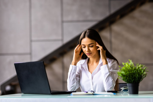 压力大的女人坐在办公桌前从家庭办公室工作图片下载