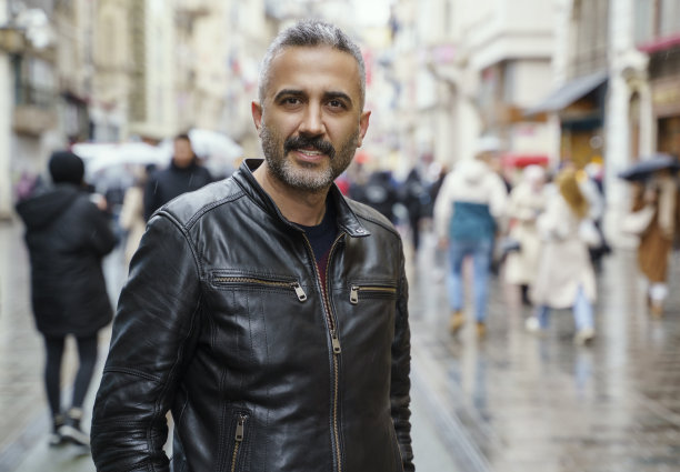 一个中年男子站在Istiklal街，看着相机的肖像图片下载