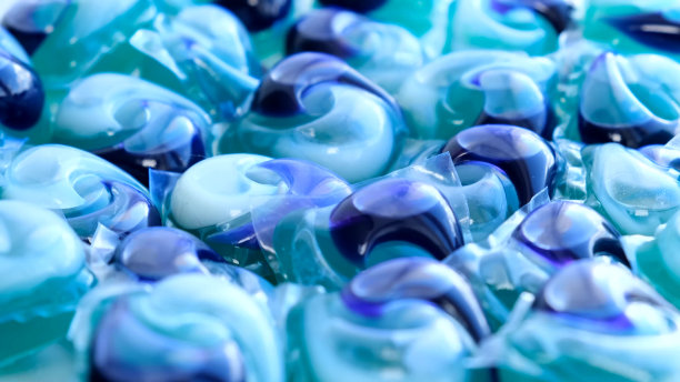 背景是用于洗衣服的凝胶胶囊，带有洗衣机洗涤剂的胶囊。图片下载