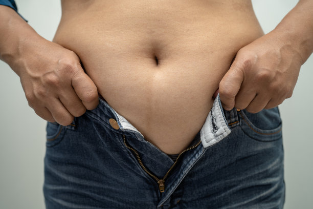 超重的亚洲女性在办公室会露出大肚子。图片下载