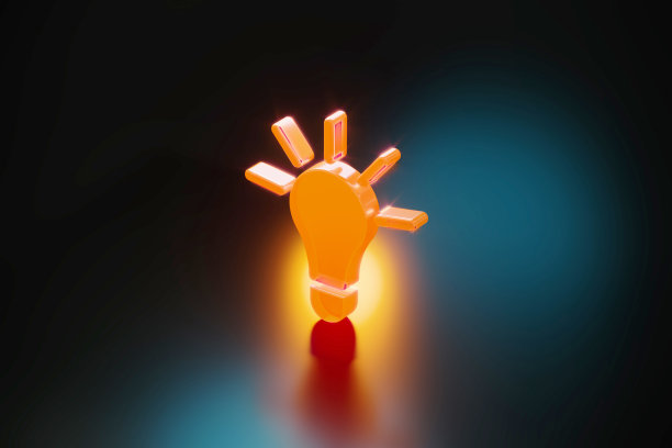 黄色灯泡符号在黑色背景上发光图片下载