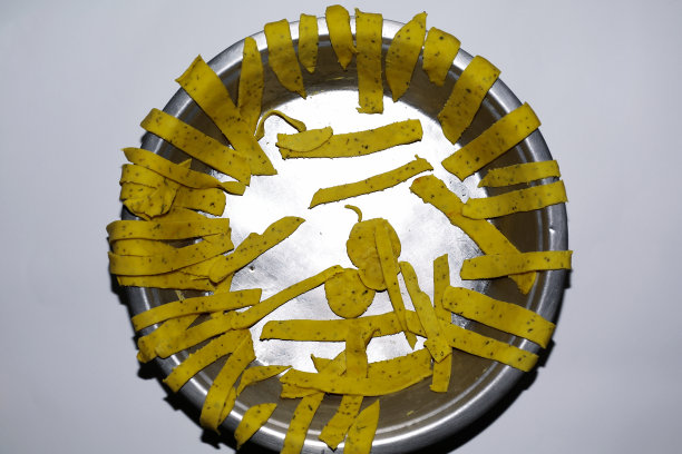 将擀好的薄面团切成条状放在白底盘上图片下载