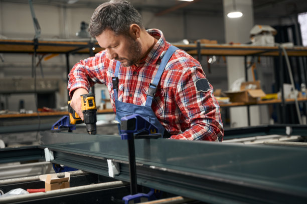 工厂中连接金属零件的成年男性图片下载