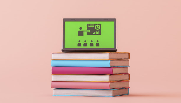 笔记本电脑放在一堆书上。在线教育图片下载