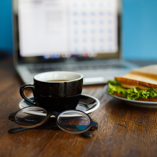 一杯美式咖啡，一副眼镜放在咖啡店的桌子上图片下载