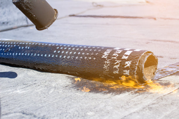 在建筑工程期间用丙烷喷灯安装卷筒屋顶图片下载