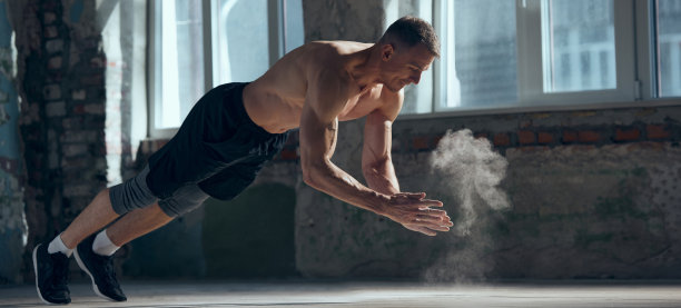 肌肉发达的年轻人用强壮的身体训练，在室内做俯卧撑练习。动力学，动作和运动。运动生活方式的概念图片下载