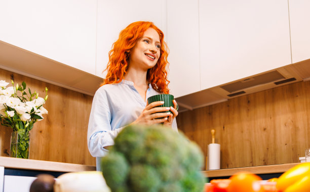 微笑快乐美丽的年轻成年人优雅的亚洲商业女性穿着西装，手里拿着杯子休息喝温暖的咖啡拿铁享受香气在咖啡店自助餐厅，垂直接近。图片下载