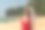 美丽的白人女性性感的女人在红色泳装比基尼海滩拿着沙滩帽戴着太阳镜笑着开心地看着大海享受海风图片下载