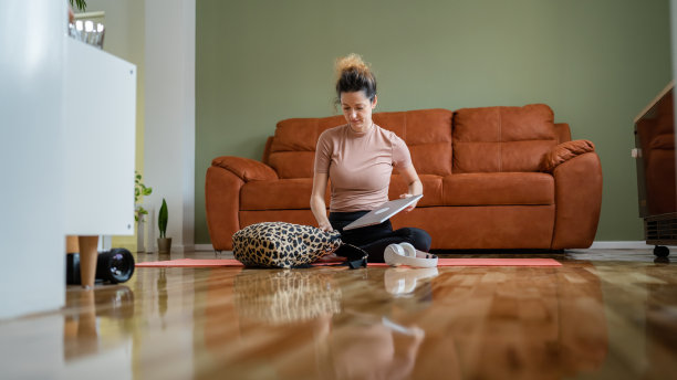 年轻职业女性平衡工作和在家做瑜伽图片下载