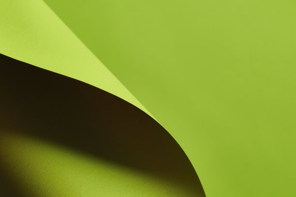 绿色的纸，卷角，页卷。抽象创意现代布局。广告和促销的设计元素。纸或页翻到右下角。背景与鲜明的阴影，对比图片下载