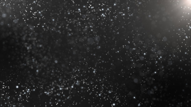 黑色背景上白色闪烁的尘埃颗粒流动。图片下载