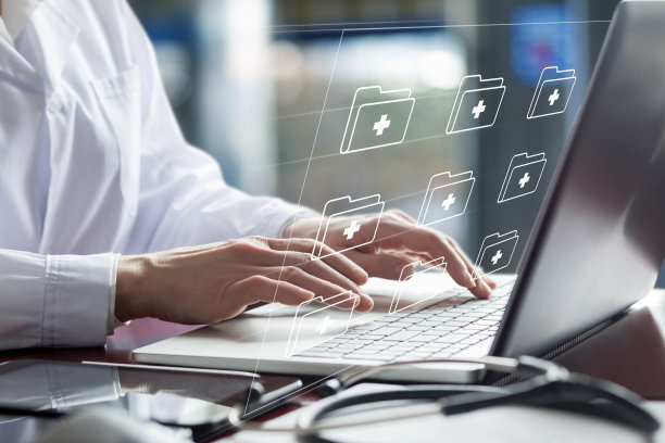 医生用笔记本电脑处理电子文件。图片下载