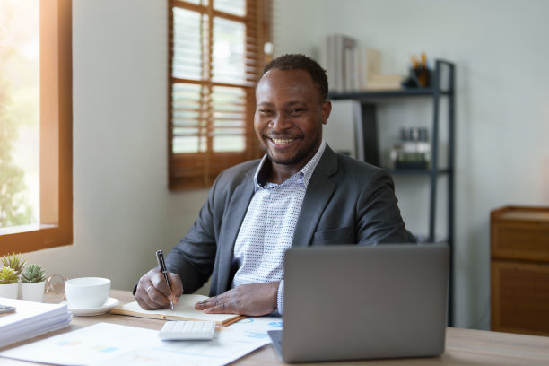 中年男子美国非洲人使用笔记本电脑与计划工作的财务文件，税务，外汇，会计和财务顾问。审计员或审计概念图片下载