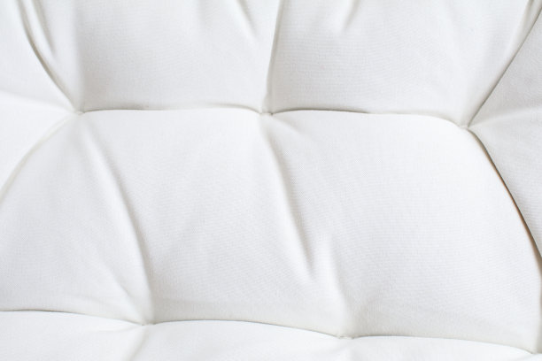 紧靠白色床垫的沙发质感。背景表面的设计艺术作品。家具簇纹壁纸。图片下载