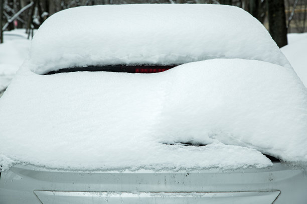 后窗上的雨刷、垫圈和刹车灯在冬天寒冷的日子里被一层厚厚的雪覆盖。图片下载
