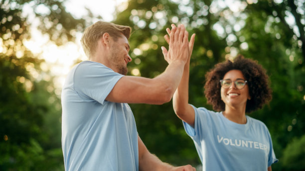 一群快乐的志愿者正在运送人道主义援助和捐赠，将箱子装进货车。慈善工作者帮助社区成员。为失业者、难民和移民提供免费膳食。图片下载