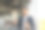 西装革履的男经理站在办公室靠窗的地方，端着一杯外带饮料，打着手机聊天图片下载