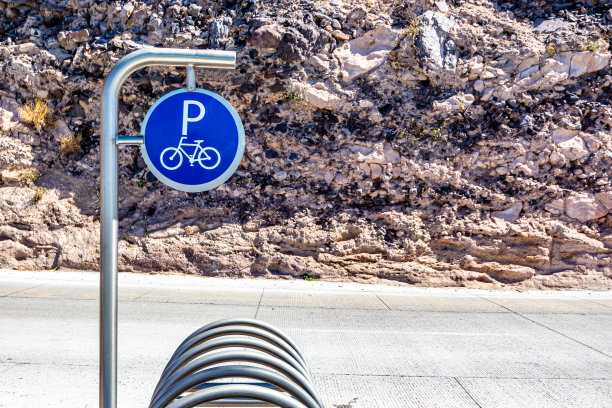 自行车停放架及其路标，联邦公路11号和岩石墙在背景图片下载