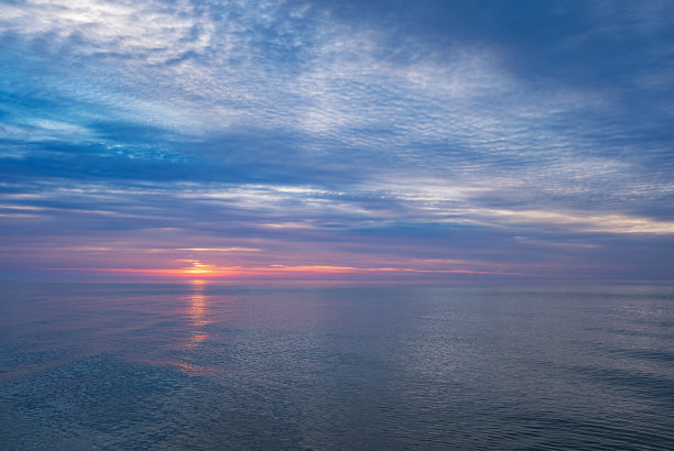 黎明在平静的海面上。自然背景图片。图片下载