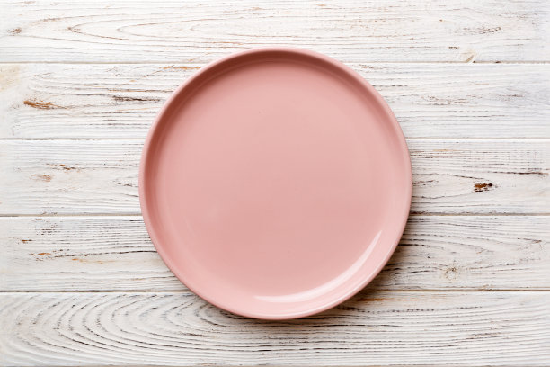 顶部视图的空粉红色盘子在木制背景。为你的设计留出空间图片下载