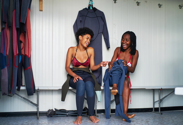 两个朋友在更衣室里穿潜水服图片下载