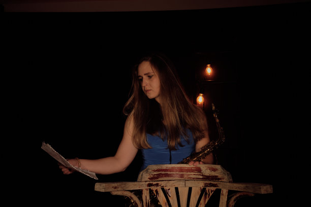 一位美丽的美国白人妇女右手拿着乐谱，正在查看乐谱图片下载