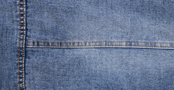 蓝色牛仔裤的背景和纹理接近。牛仔布缝。图片下载