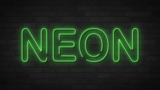 砖墙上的霓虹灯绿字。夜晚的霓虹灯装饰。图片下载