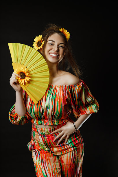 拿着一把黄色扇子的漂亮女人图片下载