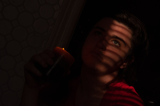 百叶帘在阳光照射下在女性脸上形成了线条图片下载